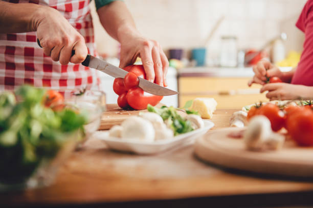 istock Mother and daughter preparing pizza 643046654