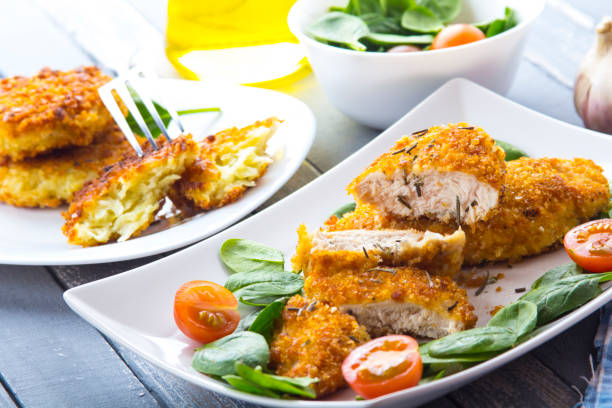 istock Food fried breading chicken spinach salad tomatoes pancakes from potatoes 643047914