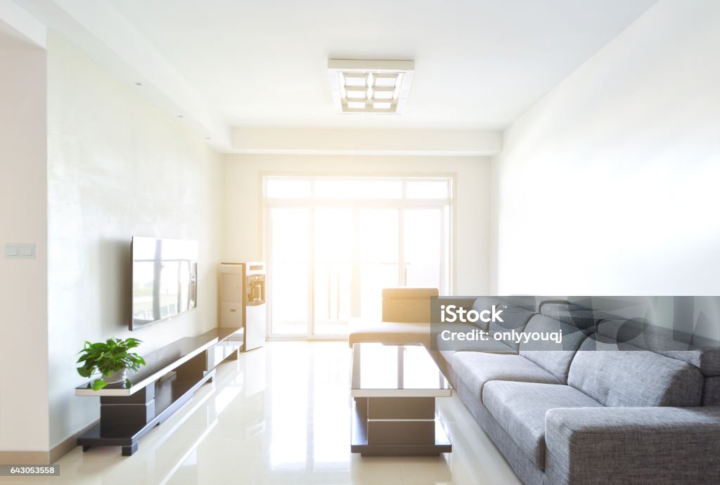 Modern and clean decoration of an apartment with a sofa and a lamp Apartment Stock Photo