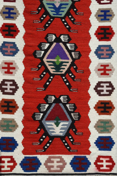 Close up of a hanged colorful handmade traditional wool rugs - abstract texture -vintage background with red, white, black and blue colors