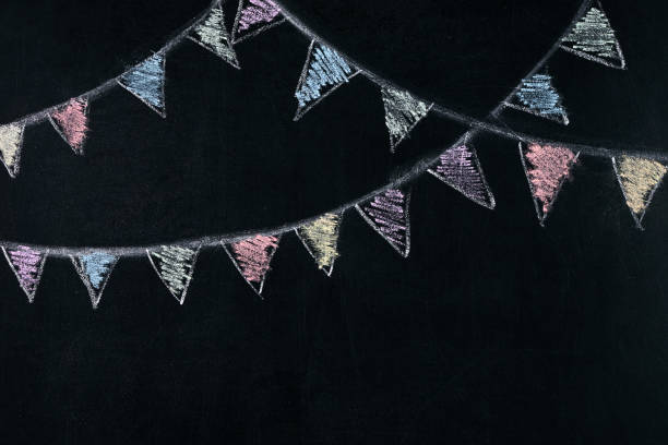 istock Colored flags on a rope drawn on blackboard, chalk board 643057508