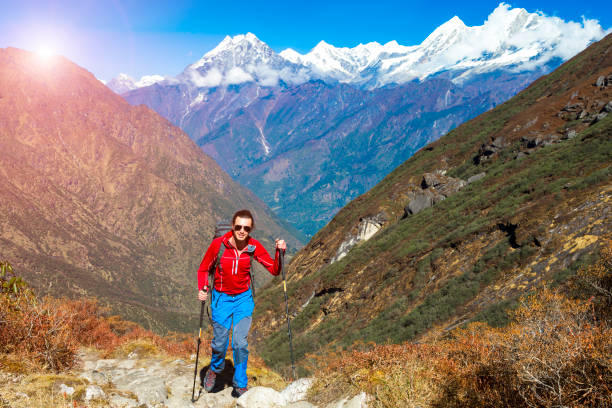 istock Young Hiker walking on Mountain Trail Sun on Background 643059802