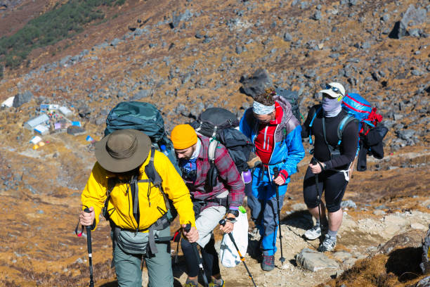 Group of People walking up on Mountain Trail