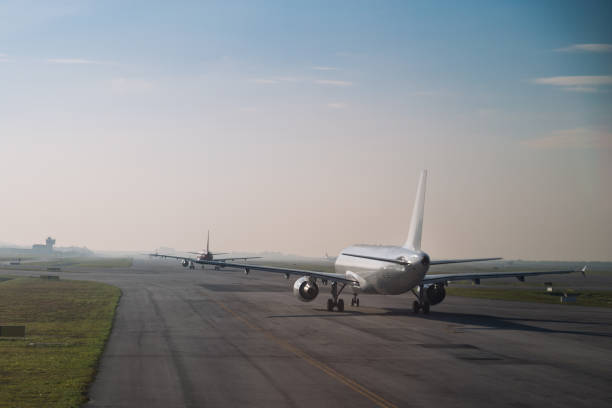 istock Commercial airplane queue taxiing to take off on runway 643064088