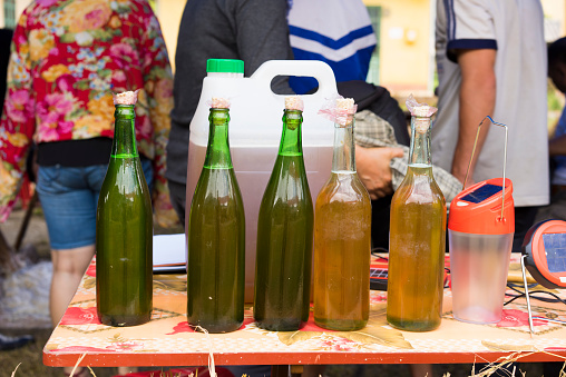 Bottles of bee's honey displayed for selling in mountainous road of Vietnam