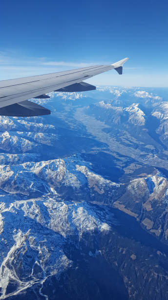 istock airplane wing over snow-covered mountains - alps europe 643070914