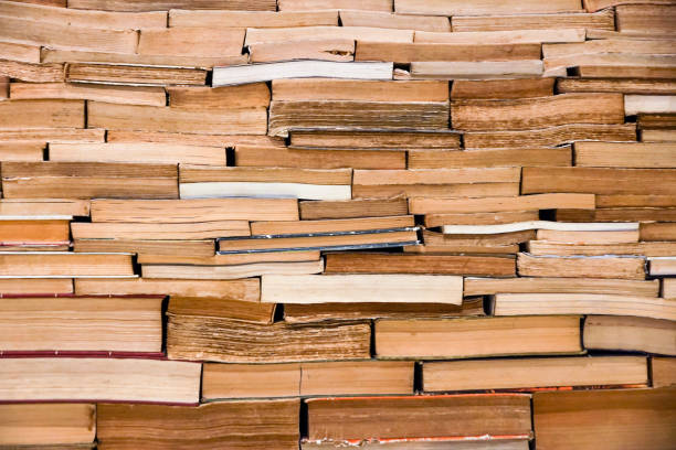 istock bookcase with many old books in a library. Book wall 643073428