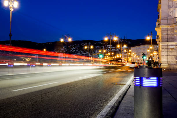 istock Illuminated road along Daugava river and railway bridge at night in Italy 643073496