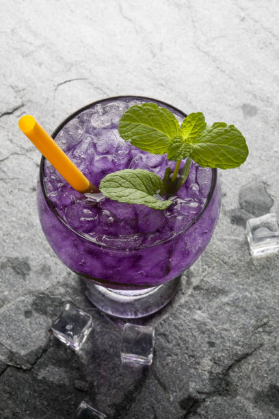 istock Purple soda lime drink with lime on stone. 643074012