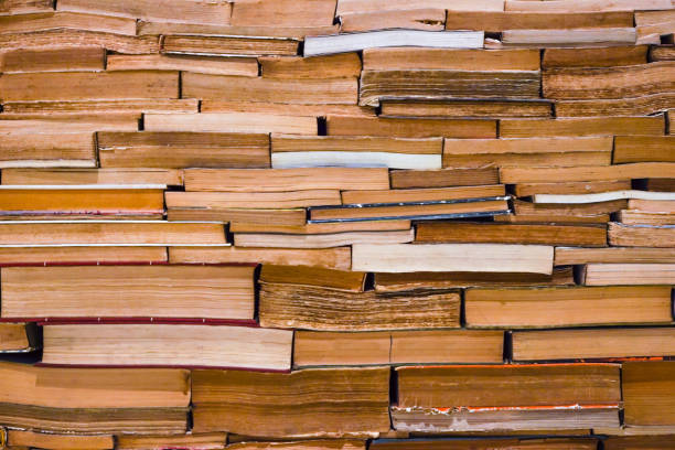 istock bookcase with many old books in a library. Book wall 643074192