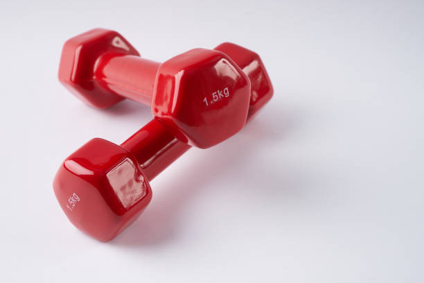 istock Closeup  of red dumbbells on white background. 643074254