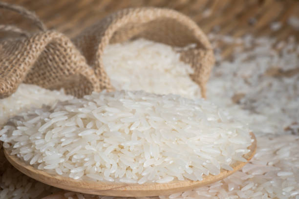 istock Closeup jasmine rice on wooden plated with blur burlab 643076756
