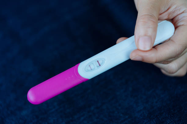 istock Woman hand holding pregnancy test. 643076758