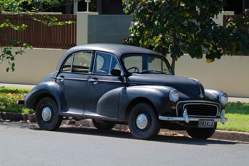 Nostalgic vintage car Morris Minor 1000 series II in black finish on street in Darwin