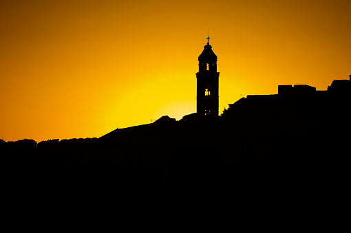 The silhouette of the city rooftops and church bell tower in Dubrovnik
