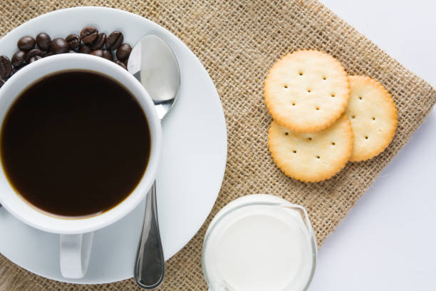 istock Cup of coffee and milk with biscuit on wooden table 643080980