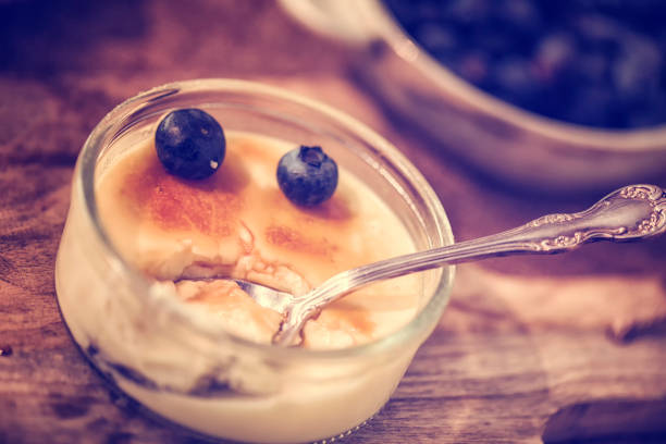 Preparing Homemade Creme Brulee with fresh blueberries
