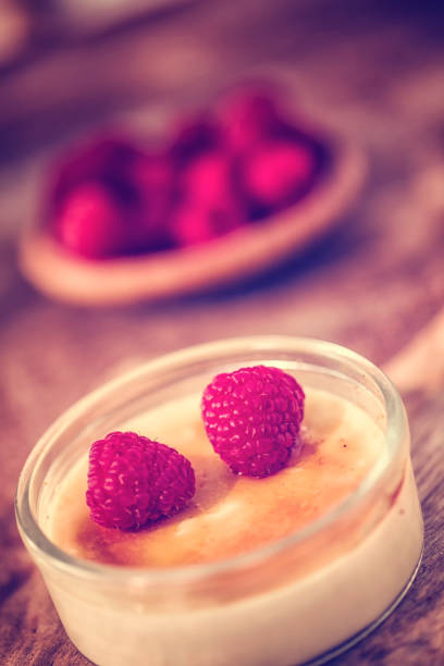 Preparing Homemade Creme Brulee with fresh raspberries