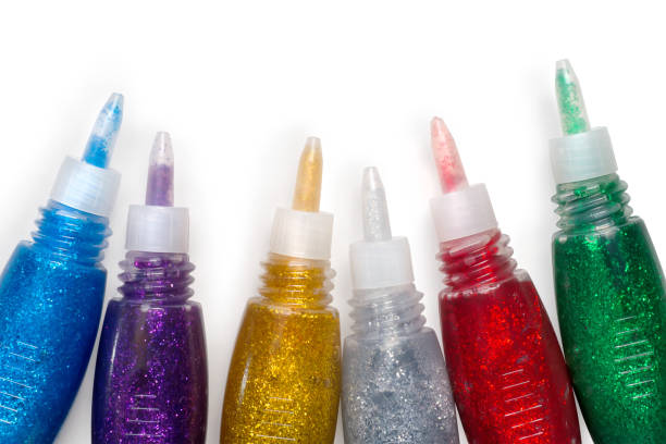 istock Set of colored glitter glue tubes on white with path 643093598