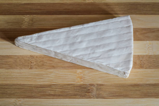 istock segment of brie cheese on wood cutting board close up 643100070