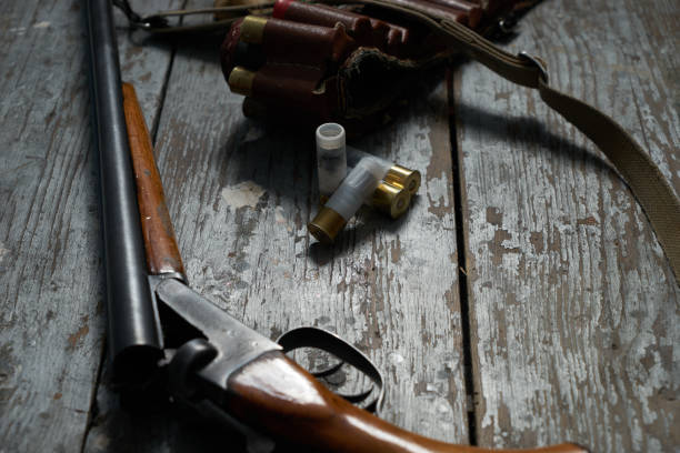 istock Hunting rifle, ammunition on the wooden old table 643100670