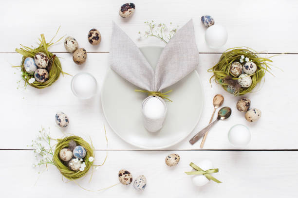 easter table decoration with napkin in the form of rabbit ears - retro revival food easter napkin imagens e fotografias de stock