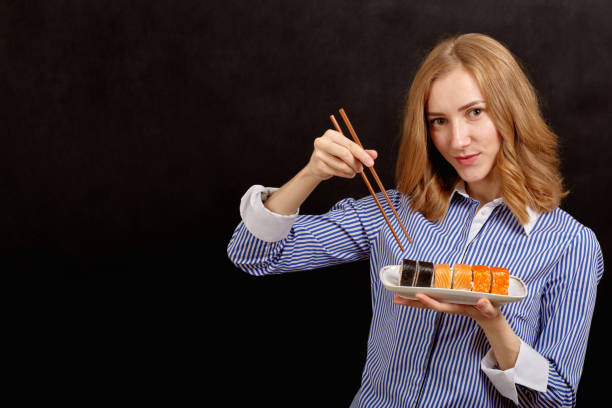 istock woman with sushi 643103888