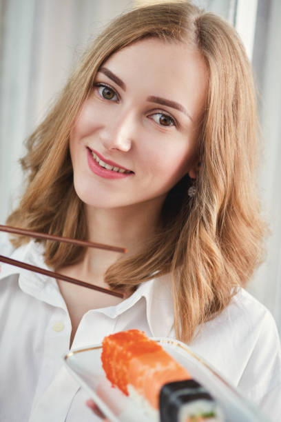 istock woman with sushi 643104052