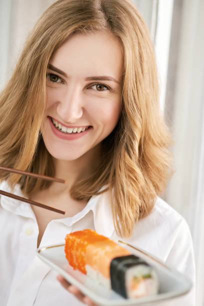 istock woman with sushi 643104080