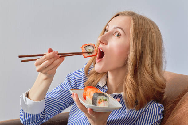 istock woman with sushi 643106296