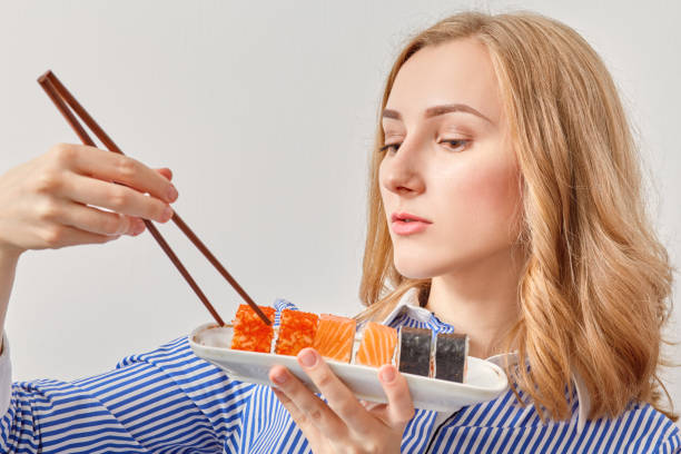 istock woman with sushi 643106308