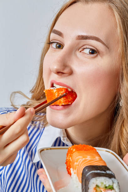 istock woman with sushi 643106338