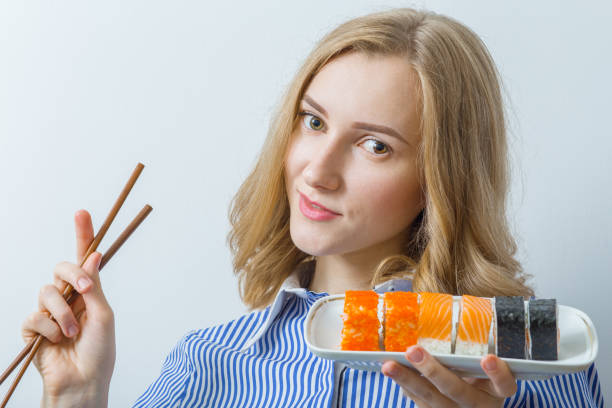 istock woman with sushi 643106368