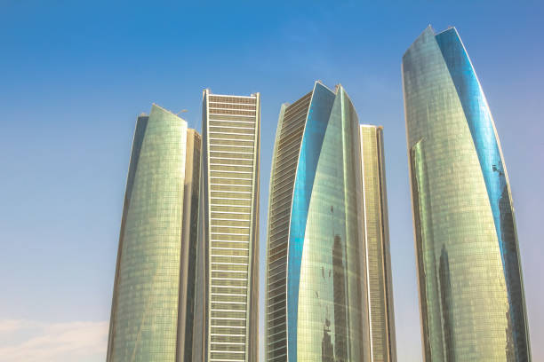 Abu Dhabi, United Arab Emirates - April 21, 2013: Etihad Towers, a complex of buildings with five towers.High rise modern buildings in the blue sky. Finance and business concept. Urban city background