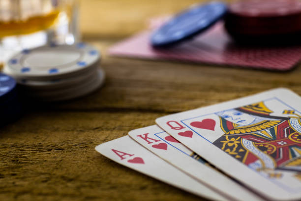 istock Playing Cards on wooden table 643113526