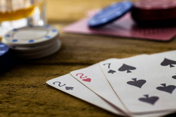 istock Playing Cards on wooden table 643113528