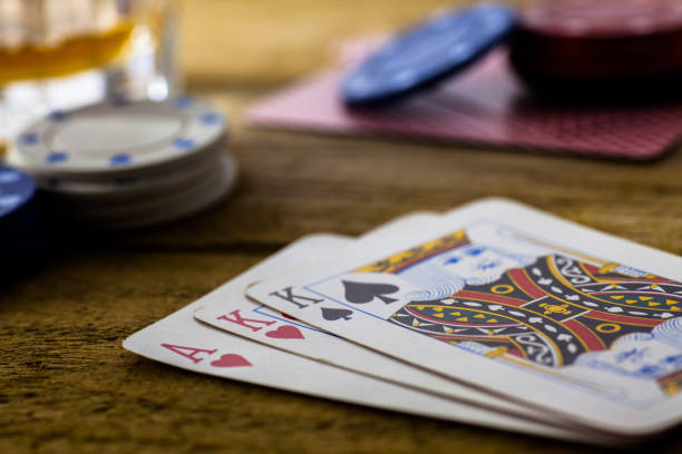 istock Playing Cards on wooden table 643113540