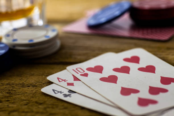 istock Playing Cards on wooden table 643113548