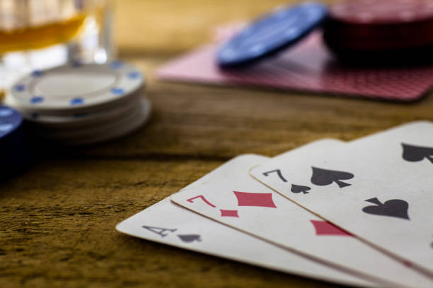 istock Playing Cards on wooden table 643113550