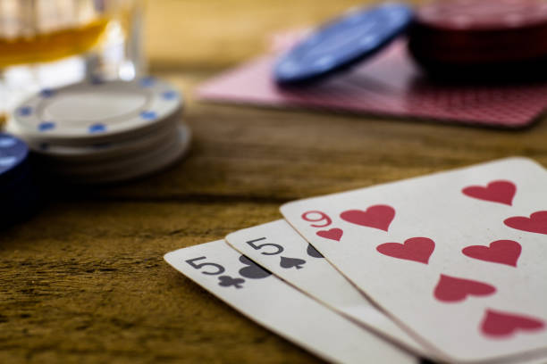 istock Playing Cards on wooden table 643113554