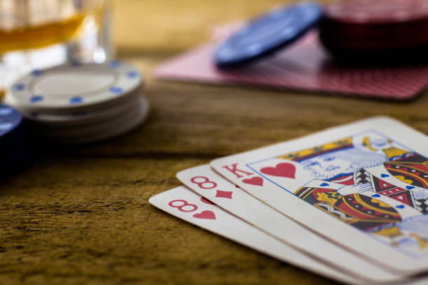 istock Playing Cards on wooden table 643113564