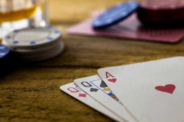 istock Playing Cards on wooden table 643113574
