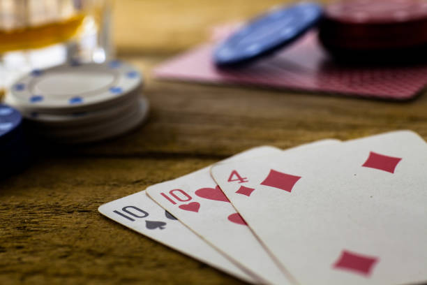 istock Playing Cards on wooden table 643113576