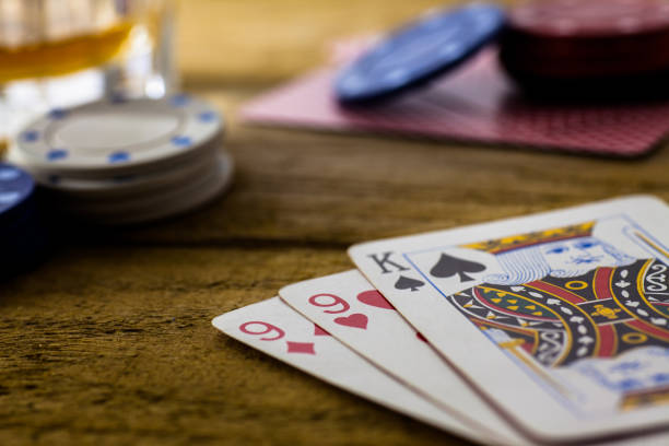 istock Playing Cards on wooden table 643113578