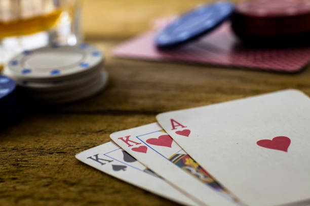 istock Playing Cards on wooden table 643113594