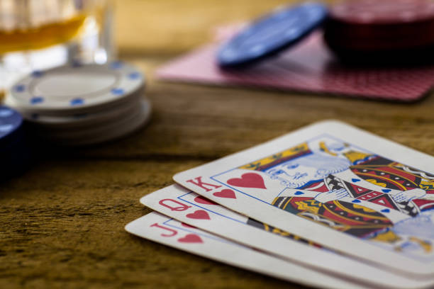 istock Playing Cards on wooden table 643113650