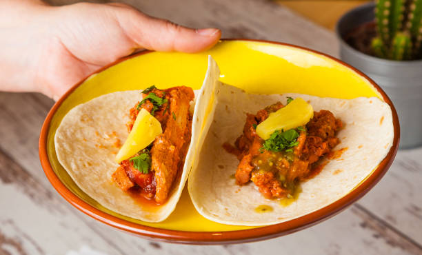 istock Serving Mexican food: tacos with spicy beef and pineapple. 643113878