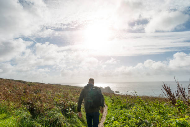 istock man walking along the South Cornish Coast path near Porthcurno 643119550
