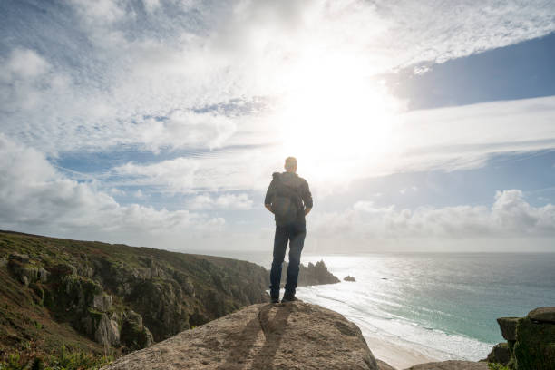 istock Man stood on cliffs enjoying the view, South Cornwall. 643119560