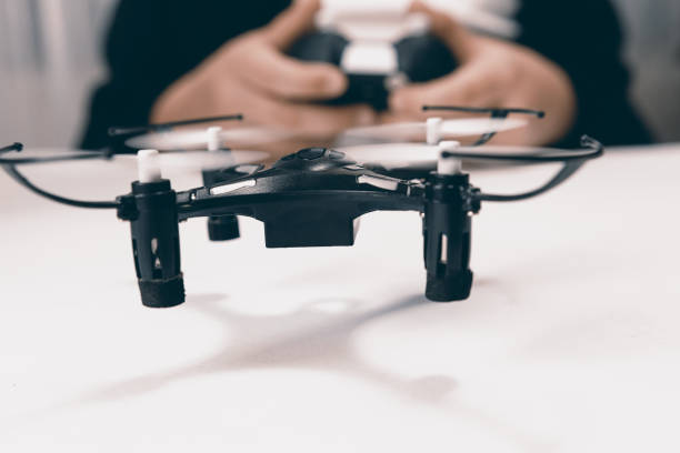 istock Boy Playing With A Small Quadrocopter Drone Close-up. 643120074